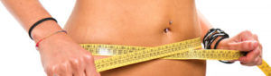 A slim girl measuring her waist